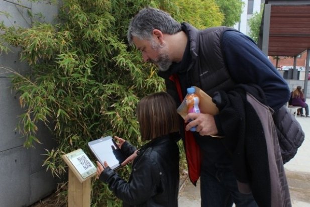 Oriol Vicente, de l'Arxiu d'Història, provant el codi QR de la plaça Calissó_617x412