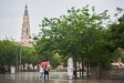 Dues dones caminen per la plaça Major sota la pluja en una imatge típicament primaveral, l'abril de 2024.