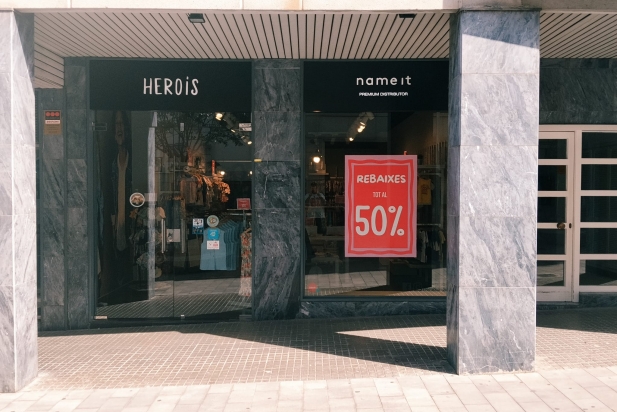 Un aparador d’un comerç amb el rètol de rebaixes al 50%